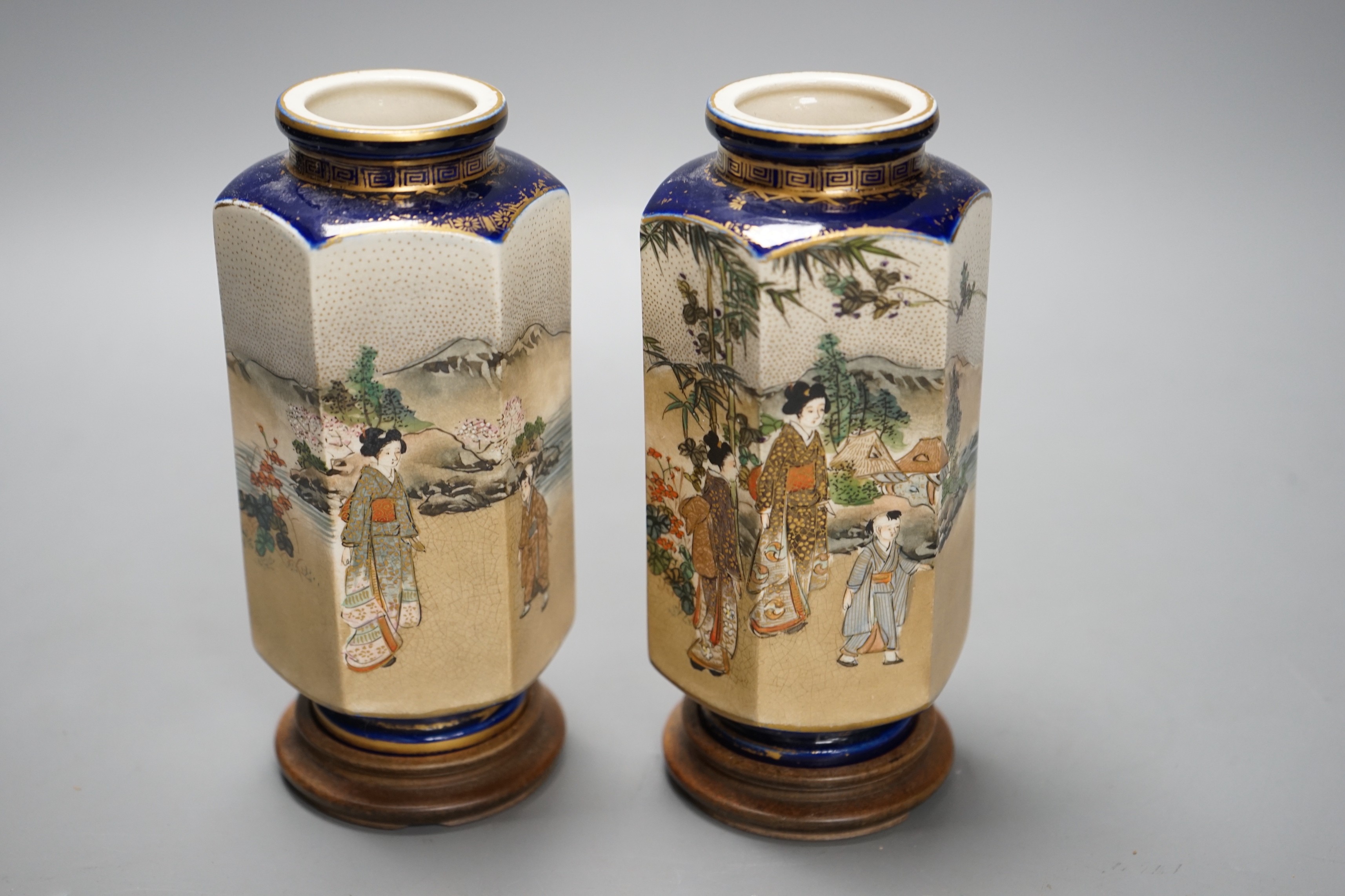 A pair of Japanese Satsuma pottery hexagonal vases, Meiji period, on stands 16cm
